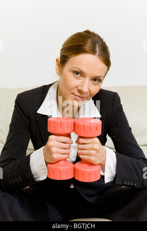 Business Woman with dumbbells Banque D'Images