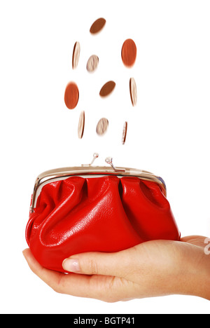 Coins falling into purse Banque D'Images