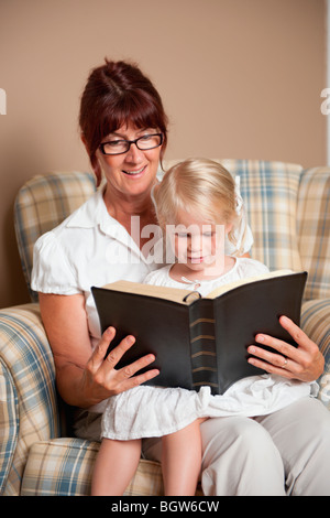 La lecture de la bible d'une grand-mère à sa petite-fille Banque D'Images