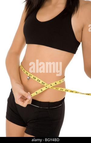 Caucasian woman measuring her waist sur fond blanc Banque D'Images