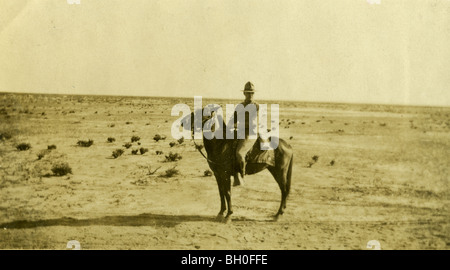 Assis sur un cheval avec désert dans l'arrière-plan. United States cavaliers le long de la frontière mexicaine Banque D'Images