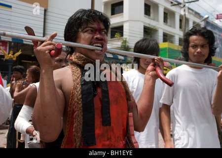 Le Festival Végétarien de Krabi, Thaïlande, implique une procession rue parfois sanglantes. Ce visage de l'homme est percé. Banque D'Images