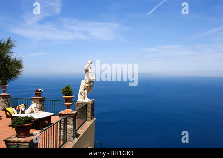 Un homme étendu à la lecture d'une terrasse avec vue sur la mer, Capri, Italie, Europe Banque D'Images