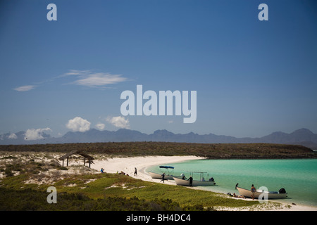 Un petit groupe de bateaux et des gens sur une plage de sable blanc, à distance près de Loreto, Mexique. Banque D'Images