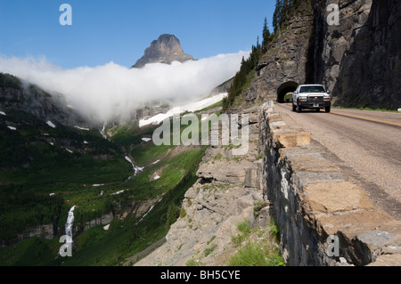 Les voitures sortent de l'Eastside comme tunnel Mt. Reynolds s'élève de Logan Pass en arrière-plan Banque D'Images