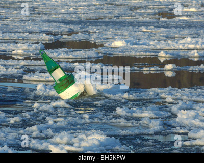 La bouée dans les glaces à la dérive sur l'Elbe près de Artlenburg, Allemagne du Nord. Banque D'Images