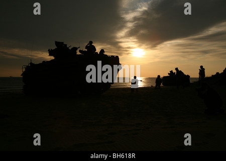 Silhouette de Marines et un assaut amphibie véhicule fournissant la sécurité sur Hwajin Beach, République de Corée. Banque D'Images