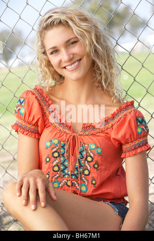 Teenage Girl Sitting in Playground Banque D'Images