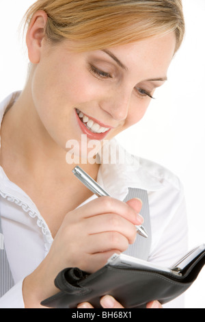 Businesswoman Writing in Diary Banque D'Images