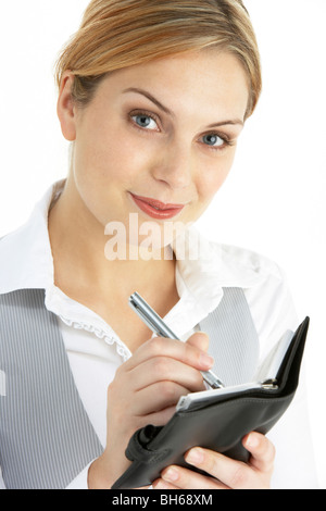 Blond Businesswoman Writing in Diary Banque D'Images