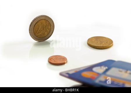 Conceptual image illustrant la concurrence e-argent vs l'argent comptant. L'accent à deux euros pièce. Shallow DOF. Arrière-plan blanc. Banque D'Images