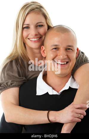 Studio Portrait of Young Couple Hugging Banque D'Images