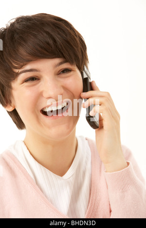 Studio Portrait of Young Girl Using Mobile Phone Banque D'Images