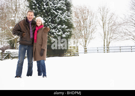 Senior Couple Walking in Snowy Landscape Banque D'Images