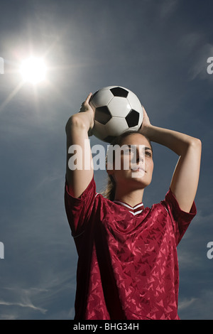 Woman holding football