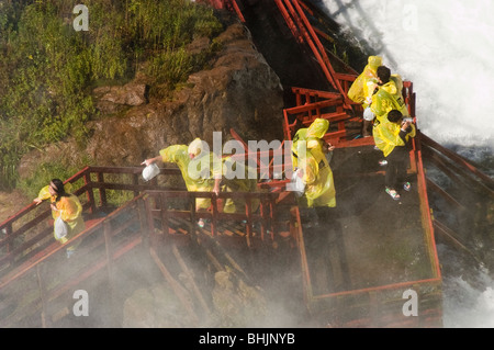 Les touristes en jaune d'imperméables visiter la cave des vents, Niagara Falls, États-Unis Banque D'Images