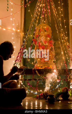 Un Brahmane bénit une statue de Ganesh, le dieu éléphant du panthéon hindou, au cours de Ganpati à Puri, Orissa, Inde Banque D'Images