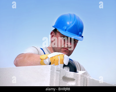 Appliquer le mortier à l'aide d'une truelle Mason sur mur de la maison de la couche de briques Banque D'Images