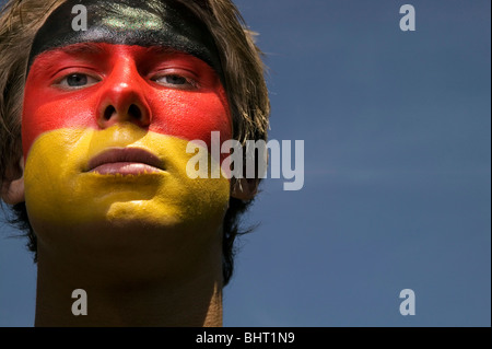 Un front patriotique et sérieux à la fédération allemande de football supporter avec le drapeau de l'Allemand peint sur son visage Banque D'Images