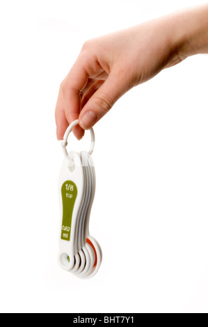 La main avec cuillères à mesurer Banque D'Images