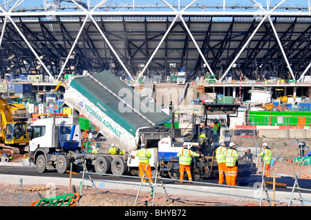 Gros plan du camion-benne basculant le tarmac dans la route de la machine de pose nouvelle route sur le site de construction du stade olympique 2012 Stratford, Londres, Royaume-Uni Banque D'Images