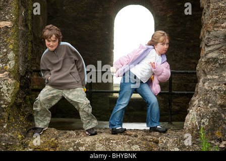 Frère et sœur jouant dans les ruines du château. Modèle entièrement libéré Banque D'Images