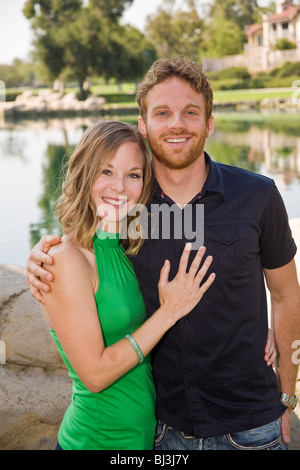 Attractive Young couple portrait Standing together at lakeside park main occasionnels sur la poitrine Caucasian United States Monsieur © Myrleen Pearson Banque D'Images