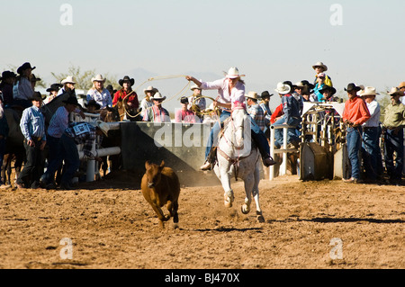 Une cowgirl est concurrentiel dans le breakaway roping évènement durant un rodéo shcool Banque D'Images