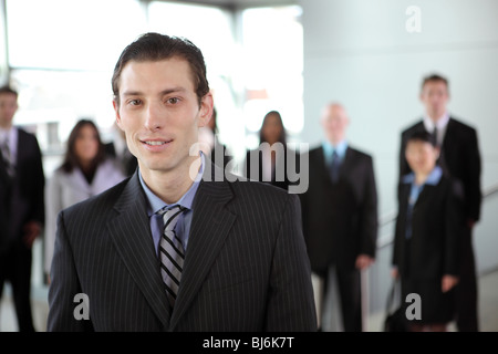 Portrait of young businessman with people in background Banque D'Images