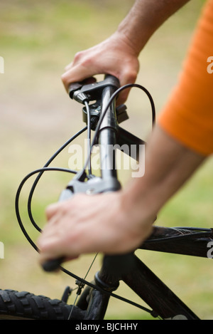Personne riding bicycle, cropped view