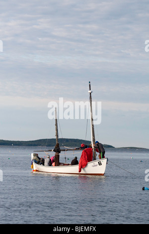 Les plaisanciers partant pour se préparer pour un autre jour à flot après avoir passé la nuit à l'ancre à Port Clyde Harbor, Maine Banque D'Images