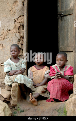 Les jeunes pygmées regarder une danse exécutée par leurs aînés dans un village ougandais. L'Ouganda, l'Afrique de l'Est © Demelza Cloke Banque D'Images