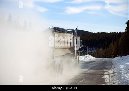 Un camion-benne passant sur un chemin de terre. Banque D'Images