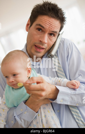 Businessman holding baby Banque D'Images