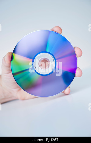 Hand holding compact disc Banque D'Images