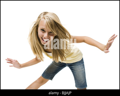 Girl Dancing with arms up smiling Banque D'Images