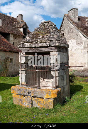 Vieux puits en pierre, dans petit village français. Banque D'Images