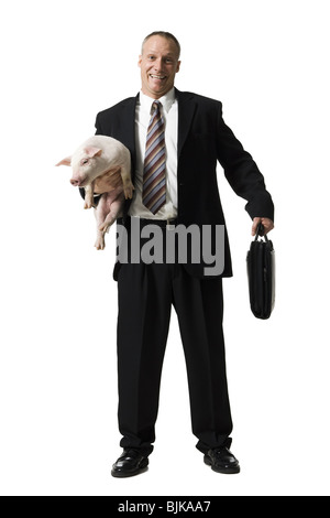 Businessman holding briefcase et Porcinet Banque D'Images