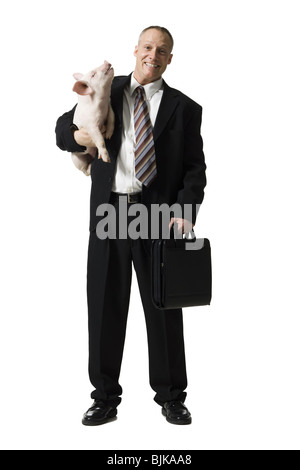 Businessman holding briefcase et Porcinet Banque D'Images