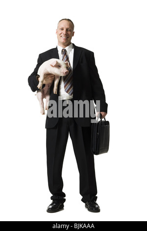 Businessman holding briefcase et Porcinet Banque D'Images