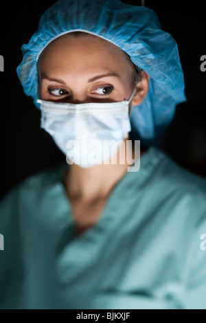 Woman in surgical scrubs looking up Banque D'Images