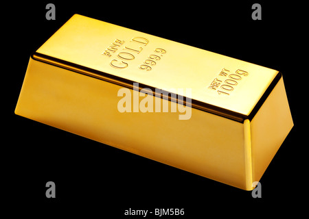 Photo d'un 1kg gold bar isolé sur un fond noir Banque D'Images