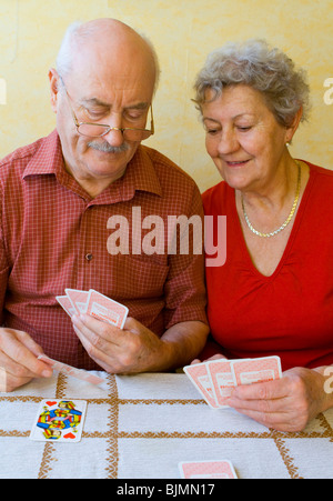 Personnes âgées couple marié, des retraités, des cartes à jouer Banque D'Images