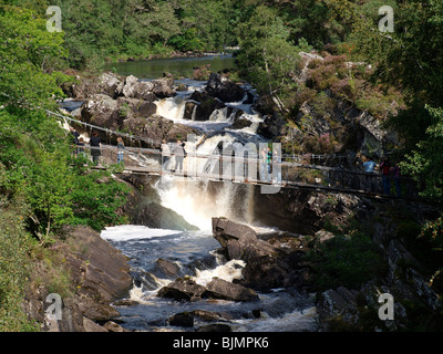 Les gens sur pont suspendu de Rogie falls sur la rivière Blackwater près de Strampeffer Banque D'Images