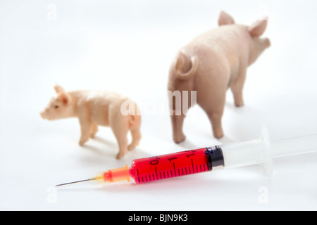 Grippe porcine A H1N1 vaccine métaphore avec toy cochons Banque D'Images