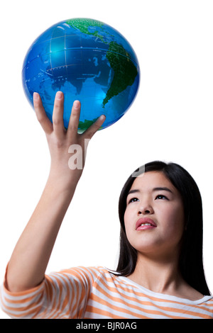 Teenage Girl standing with a globe Banque D'Images