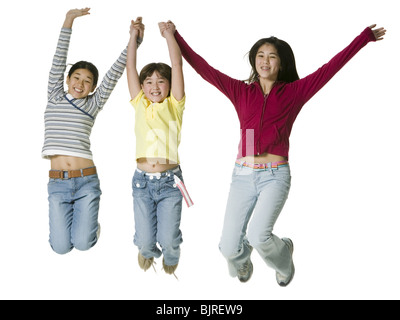 Trois enfants sautant en l'air Banque D'Images