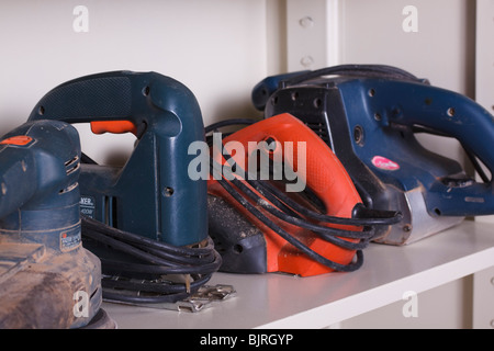 Divers outils d'alimentation potable line les étagères de l'armoire dans un atelier. Banque D'Images