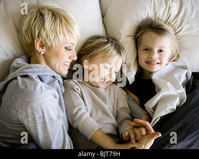 USA, Utah, Provo, Boy and girl (2-5) in bed with mother Banque D'Images