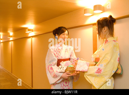 Les femmes portant un yukata debout dans le couloir parler de health spa Banque D'Images